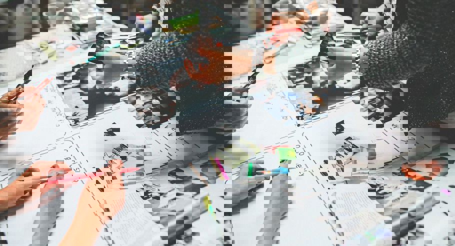 Image of the hands of people working on a magazine